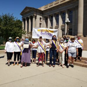 Image of WSCSC members with Bri Buentello holding banner, standing in front of Old Pueblo Courthouse